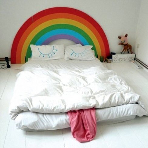 dormitorio infantil decorado con cabecero arco iris